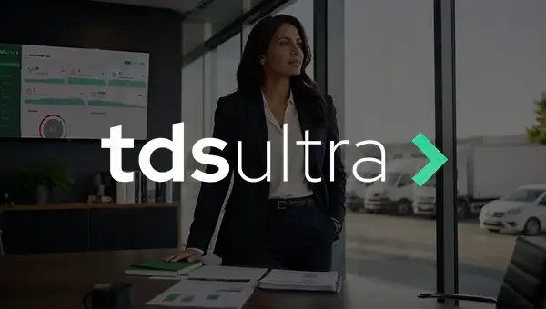 TDS Ultra — a fleet manager reviewing dashboards in a glass office